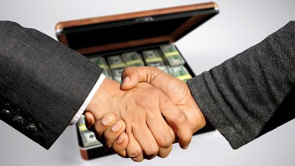 Real Estate Agent shaking hands with a broker